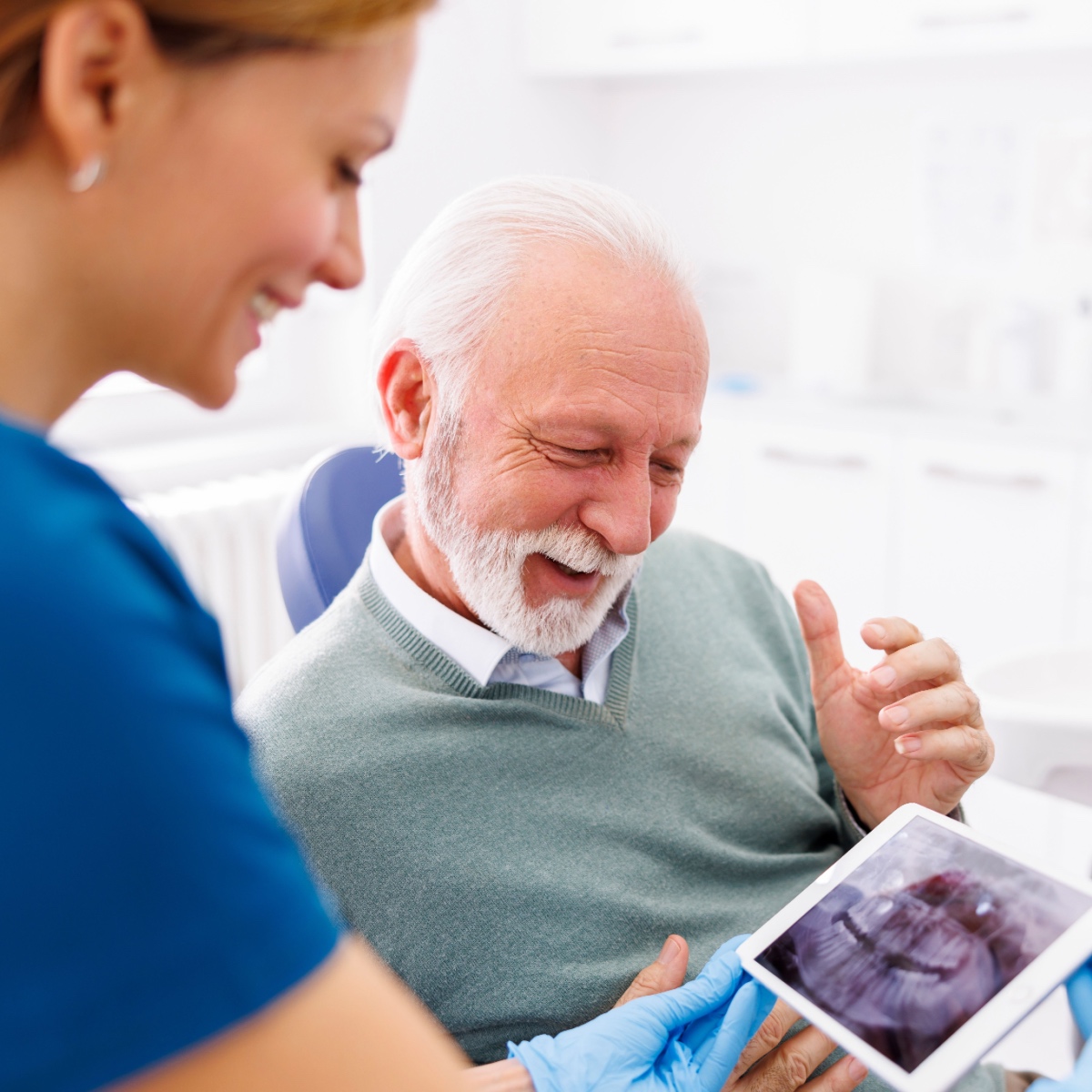 A dentist using the OrthoPhoto app with a patient